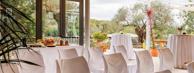 The glass Garden Room, set for a ceremony, Can Lluc Boutique Country Hotel