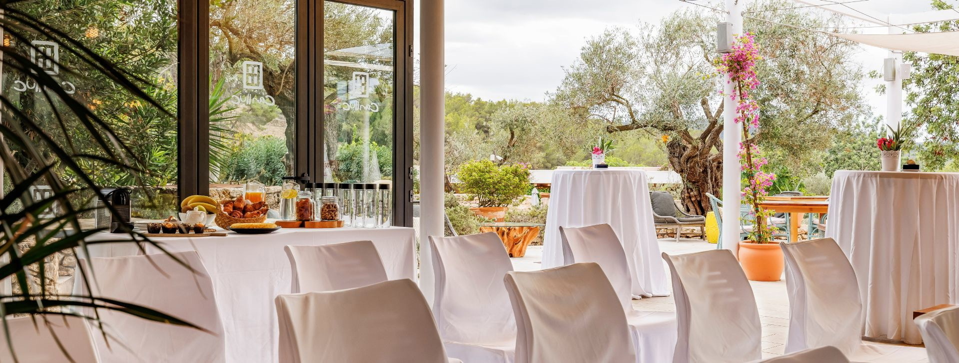 The glass Garden Room, set for a ceremony, Can Lluc Boutique Country Hotel