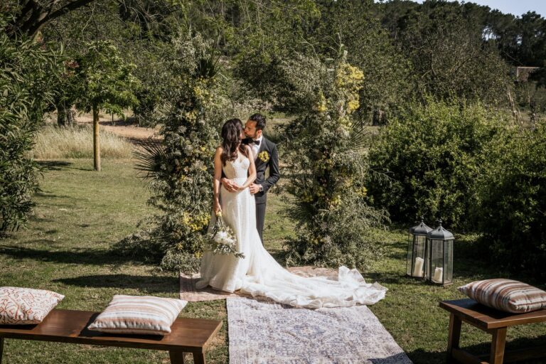 The couple at the ceremony arch, Can Lluc Hotel