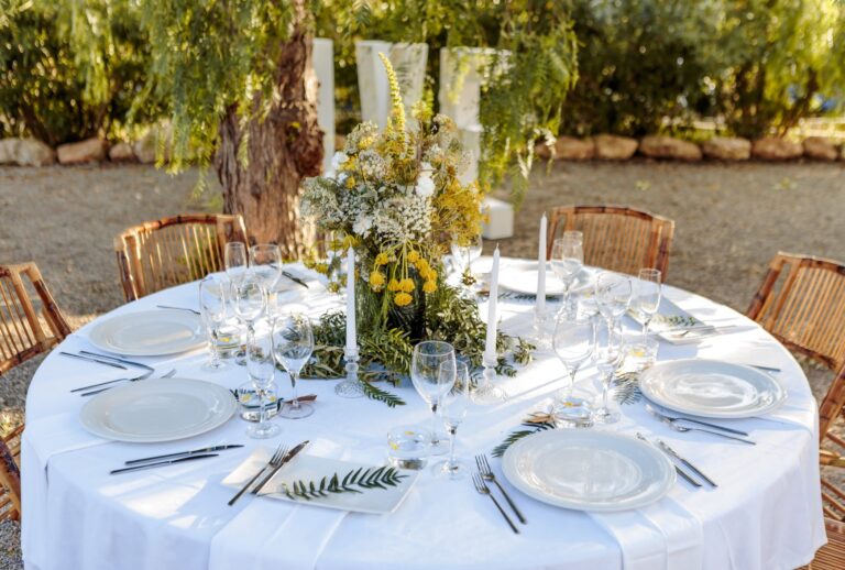 A round table set outdoors for a wedding, Can Lluc Hotel