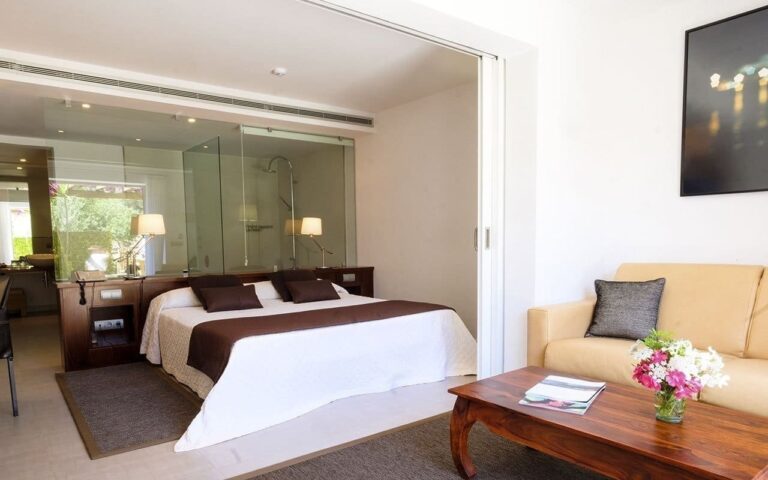 A suite bedroom and lounge, Can Lluc Hotel