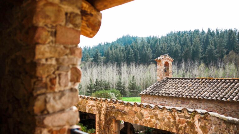 The masia and its tower, across the valley, Can Riera de la Pineda