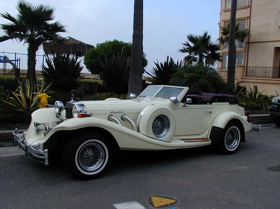 White Excalibur Phaeton cabriolet among palms, Canestri Autonoleggi, Car Hire Italy