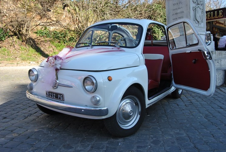 Vintage Fiat 500 with pink ribbon decoration and open door, Canestri Autonoleggi, Car Hire Italy