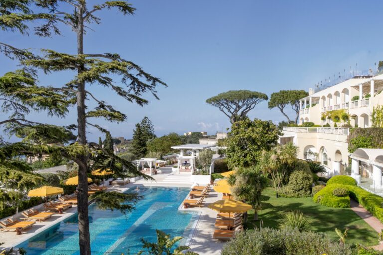The hotel and its pool terraces among gardens, seen from above, Capri Palace Jumeirah