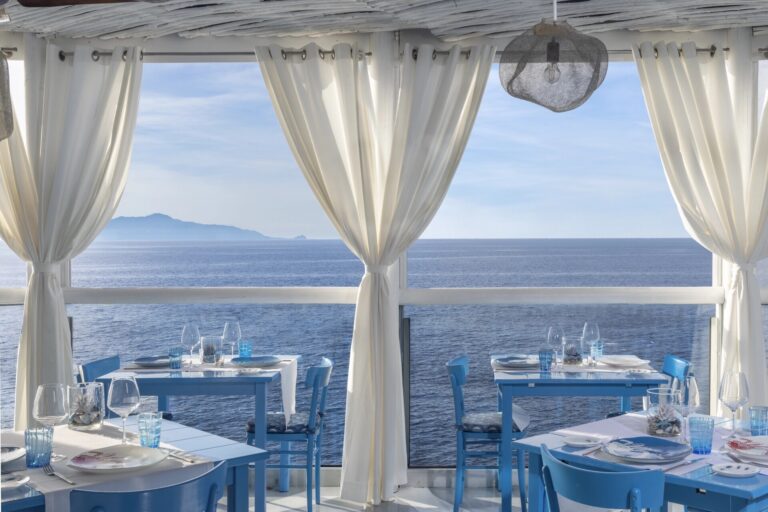 Restaurant terrace with curtains framing the sea, Capri Palace Jumeirah