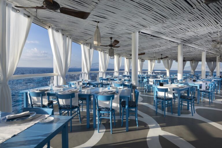 Restaurant terrace set with blue tables, Capri Palace Jumeirah