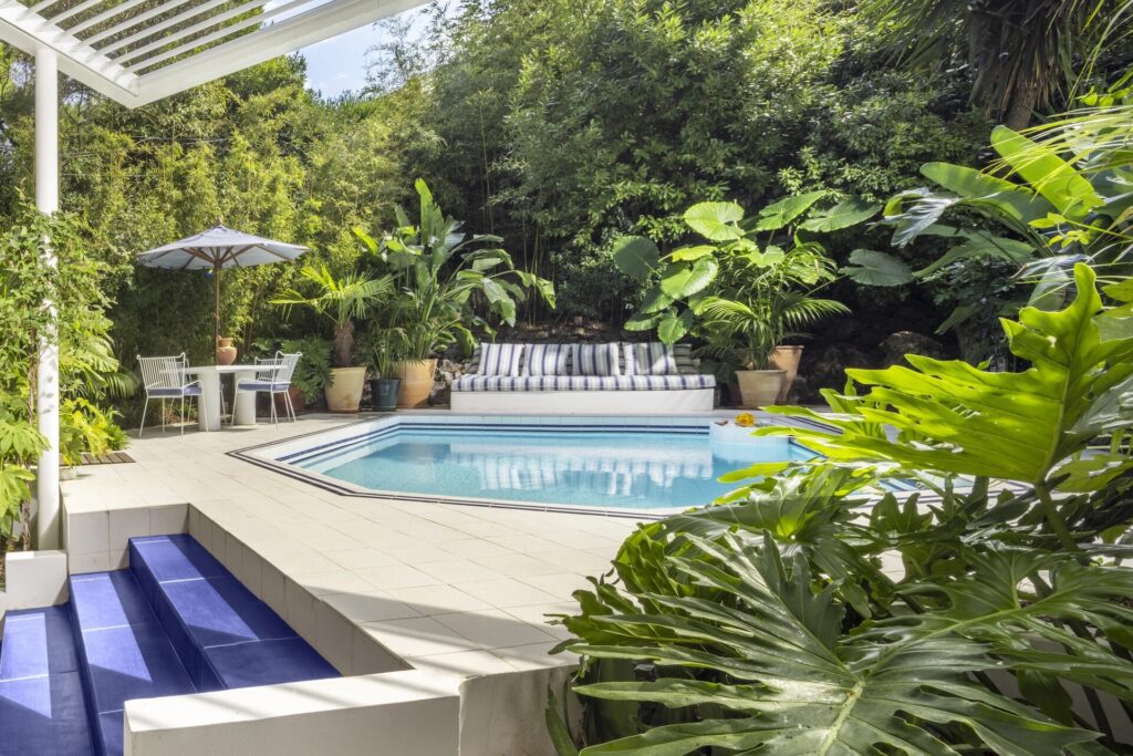 Garden pool with steps and tropical planting, Capri Palace Jumeirah