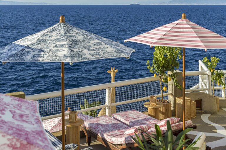Sea terrace with patterned parasols and loungers, Capri Palace Jumeirah