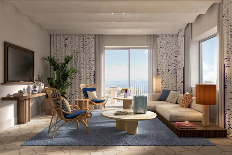 Suite living room with a sea view window, Capri Palace Jumeirah