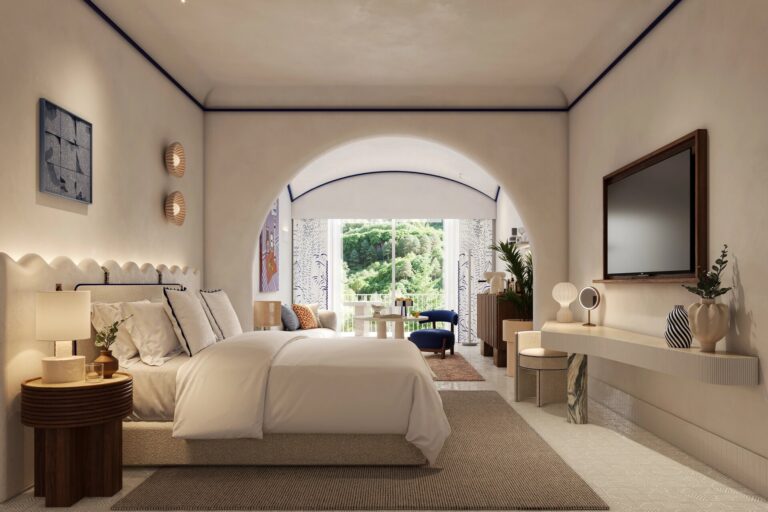 Bedroom with a panelled headboard wall, Capri Palace Jumeirah