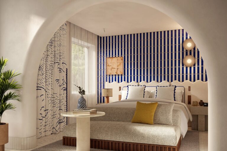 Bedroom with a striped headboard, Capri Palace Jumeirah