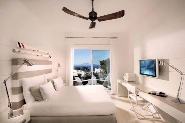 White bedroom with a sea view window, Capri Palace Jumeirah