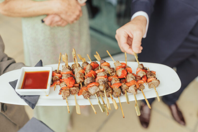 A platter of meat skewers with a dipping sauce being offered to guests at a drinks reception, Captain's Club Hotel & Spa