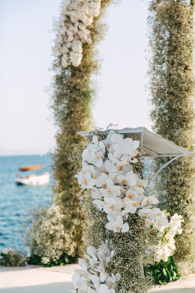Ceremony arch dressed with white orchids on the seafront, Caresse, a Luxury Collection Resort and Spa, Bodrum