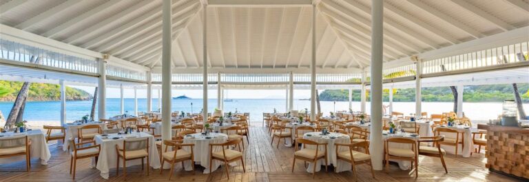 Tables set in an open-sided restaurant room, Carlisle Bay Antigua