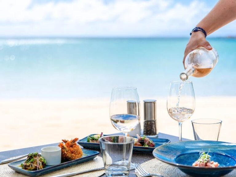 Dishes and wine served at a table by the sea, Carlisle Bay Antigua