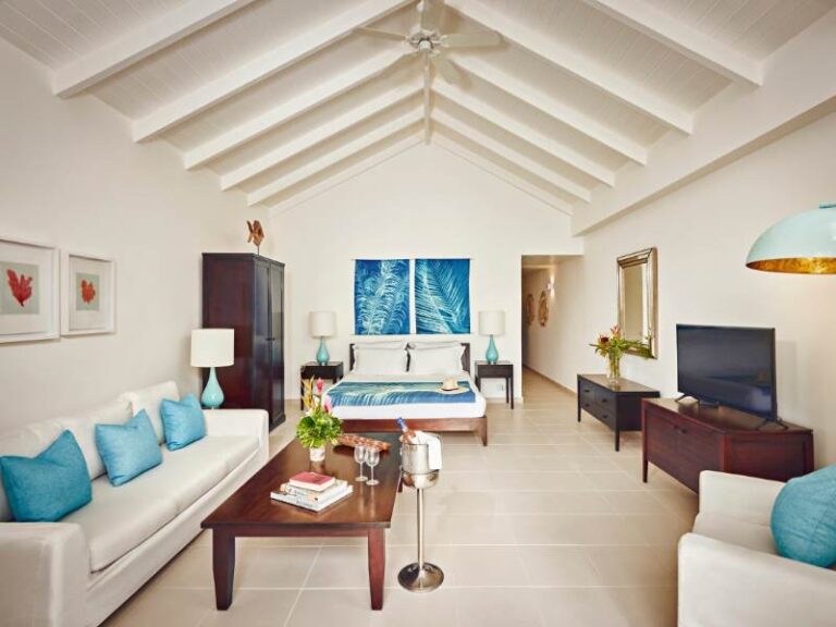 Suite living room with sofas and blue cushions (rendered image), Carlisle Bay Antigua