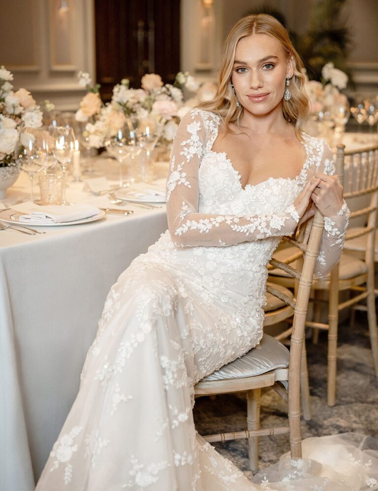 The Shaftesbury lace gown from the Icon collection at a flower-dressed table, Caroline Castigliano