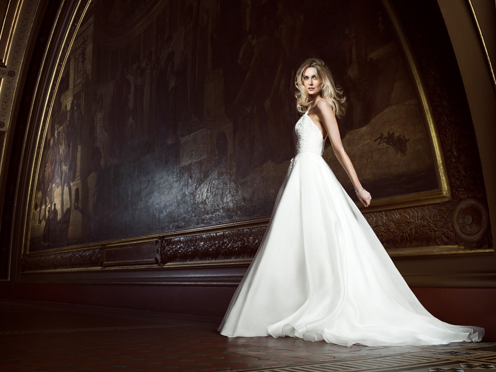 A bride in a flowing gown in a gilded, painted hall, Caroline Castigliano