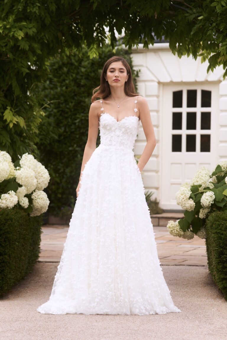 The Romance gown in a garden with white hydrangeas, Caroline Castigliano