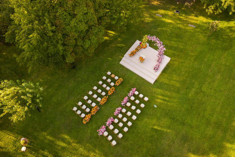 Ceremony seating and flower-covered platform on the lawn from above, Casa Lavanda