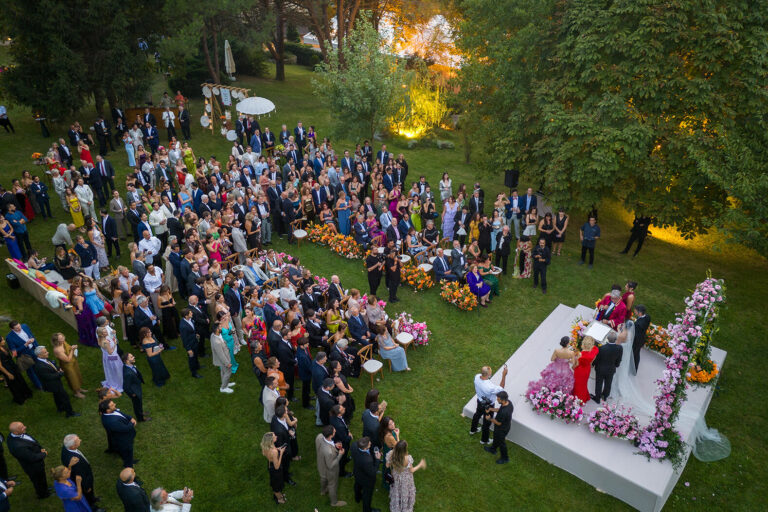Wedding guests gathered around the ceremony platform on the lawn, Casa Lavanda