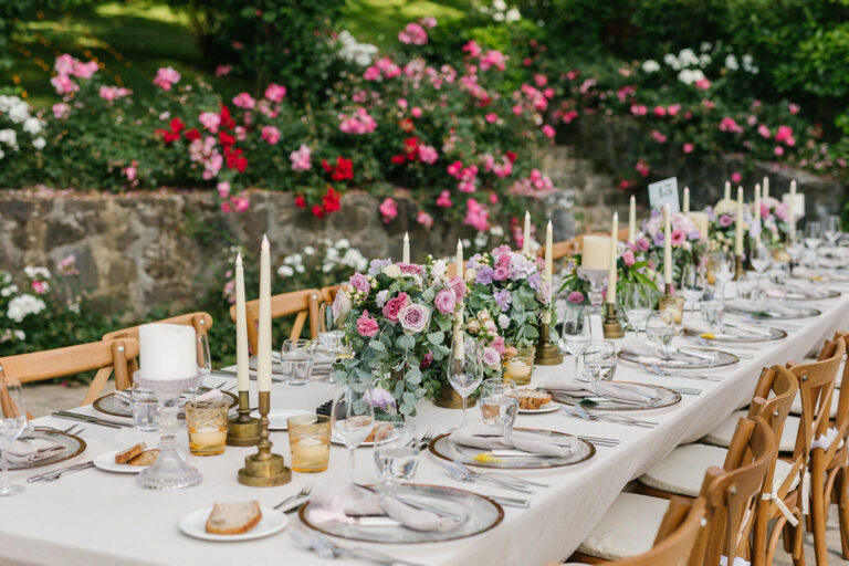 Candlelit long table set with roses in the garden, Casa Lavanda