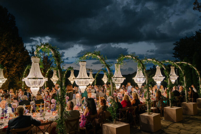 Chandeliers hung from arches over an evening reception, Casa Lavanda