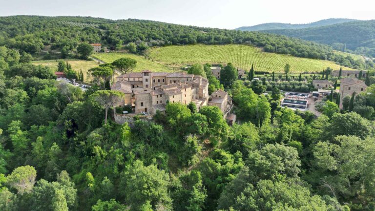 Aerial view of the medieval village among the Chianti woods, Castel Monastero