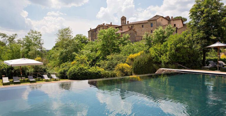 The outdoor infinity pool and the village, Castel Monastero