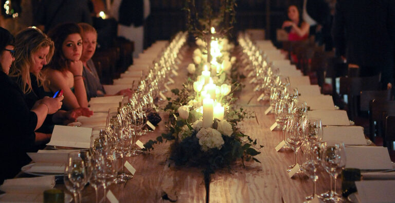 A long candlelit banquet table, Castel Monastero