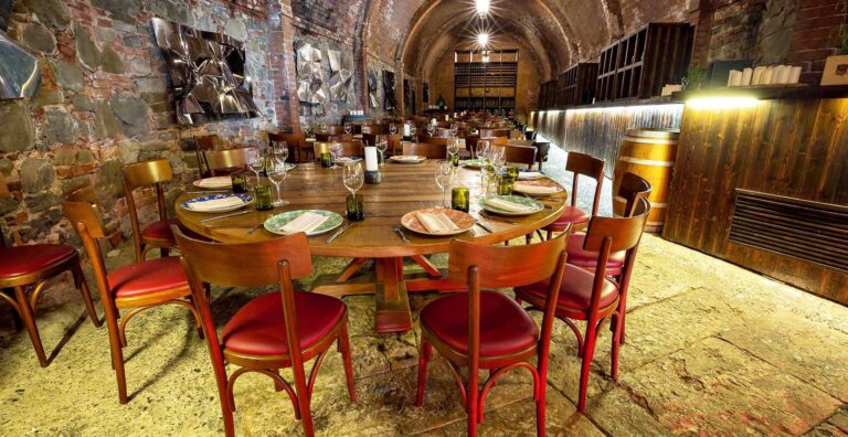 Round tables laid in the Cantina, Castel Monastero