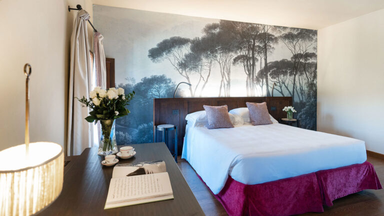 A room with a painted landscape mural, Castel Monastero