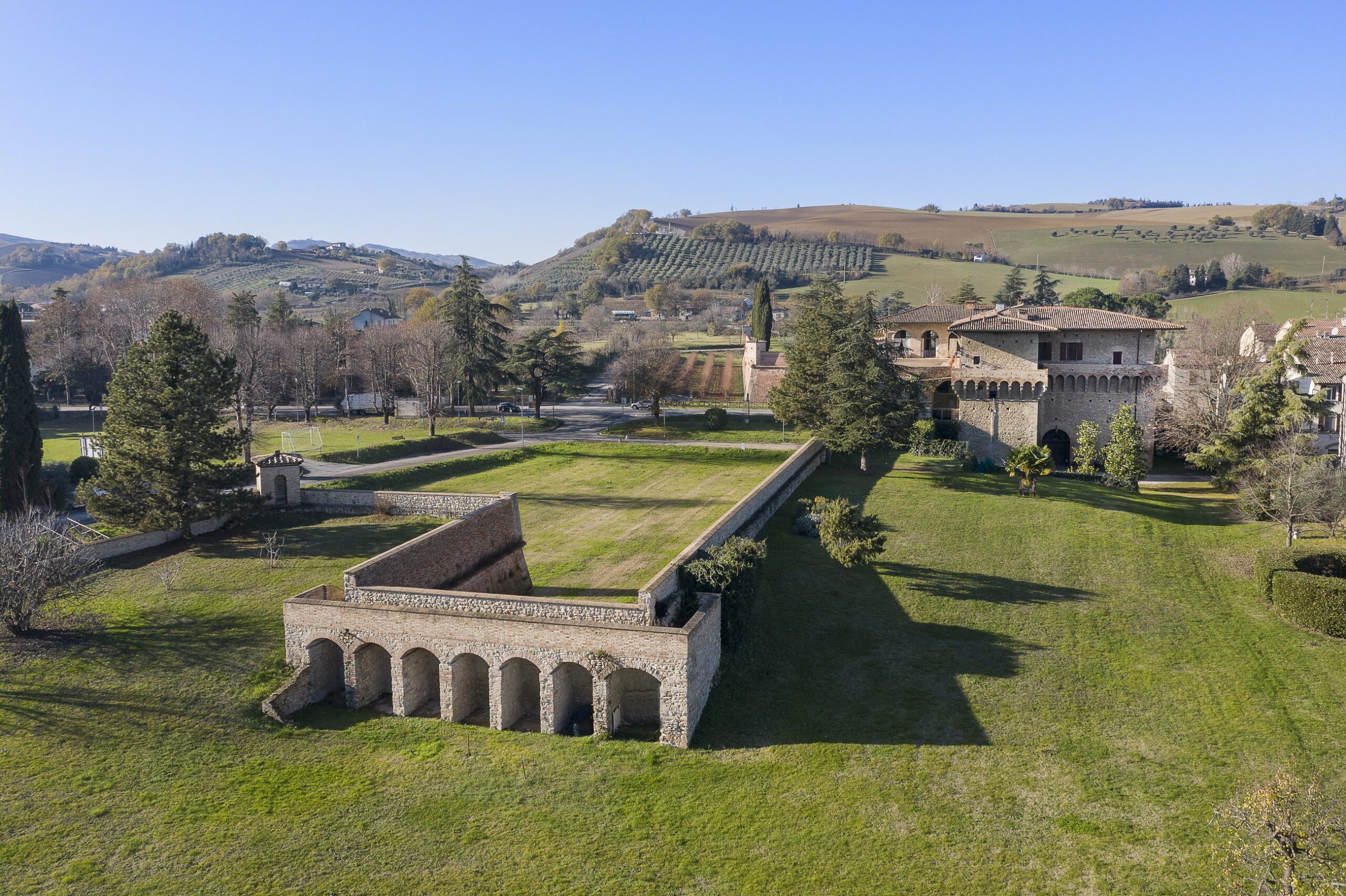 The brick loggia in the park, with the castle beyond, Castello del Capitano delle Artiglierie