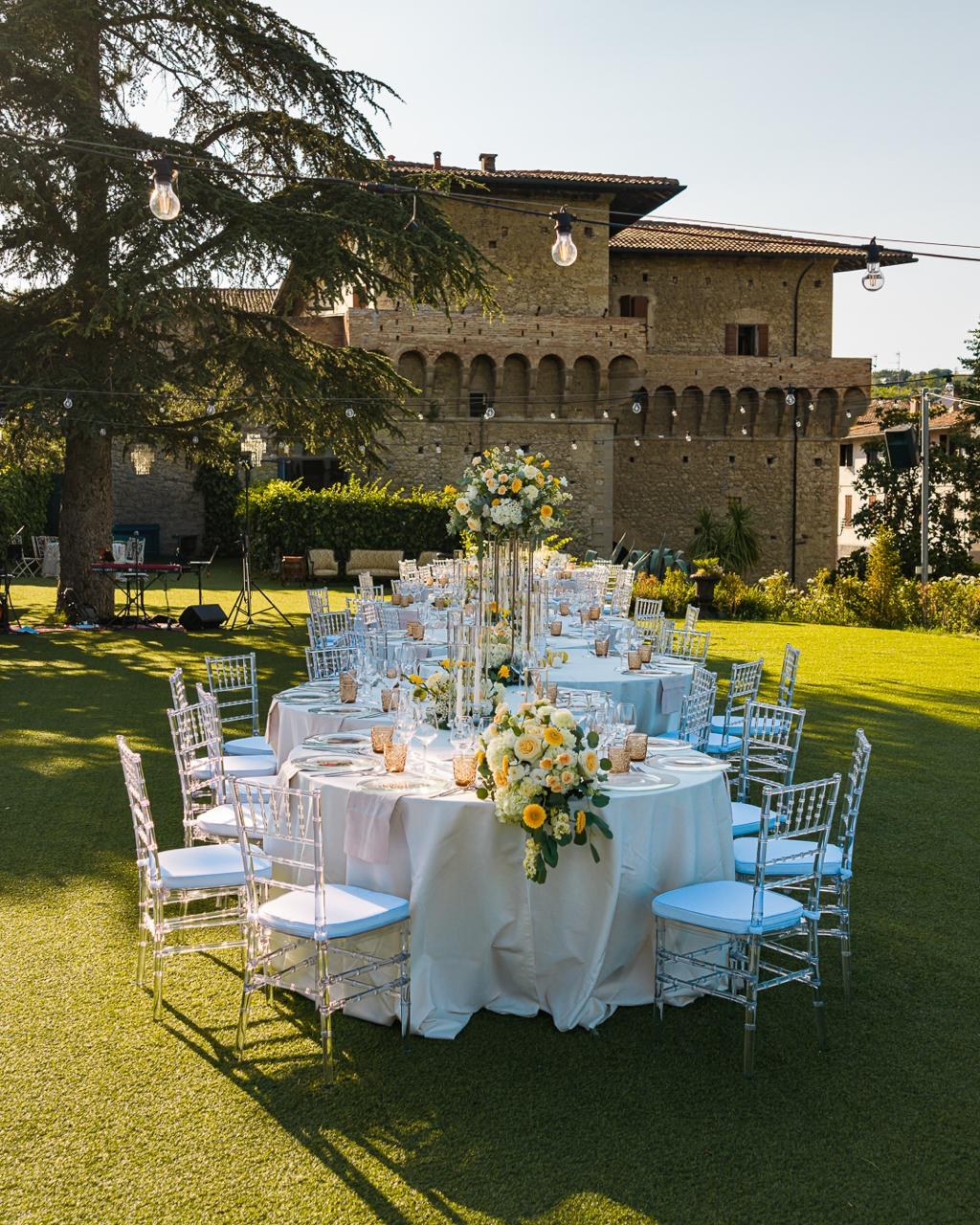 Tables laid below the castle wall in the evening light, Castello del Capitano delle Artiglierie