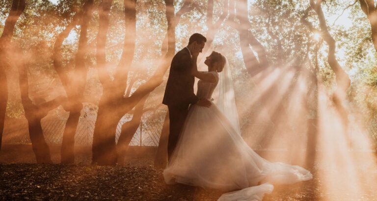Couple in golden forest light, ancient sunrays through the estate trees, Castello di Solfagnano