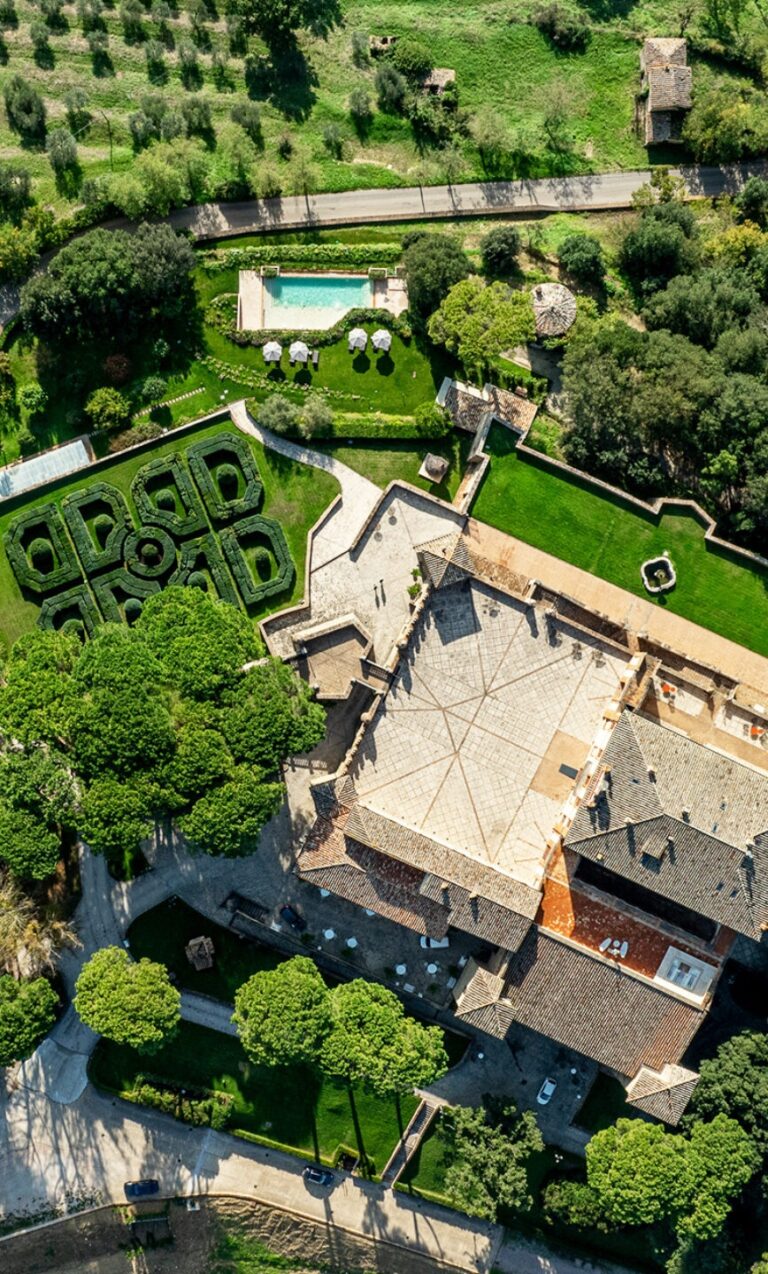 Aerial of the castle, formal garden and outdoor pool, Solfagnano, Castello di Solfagnano