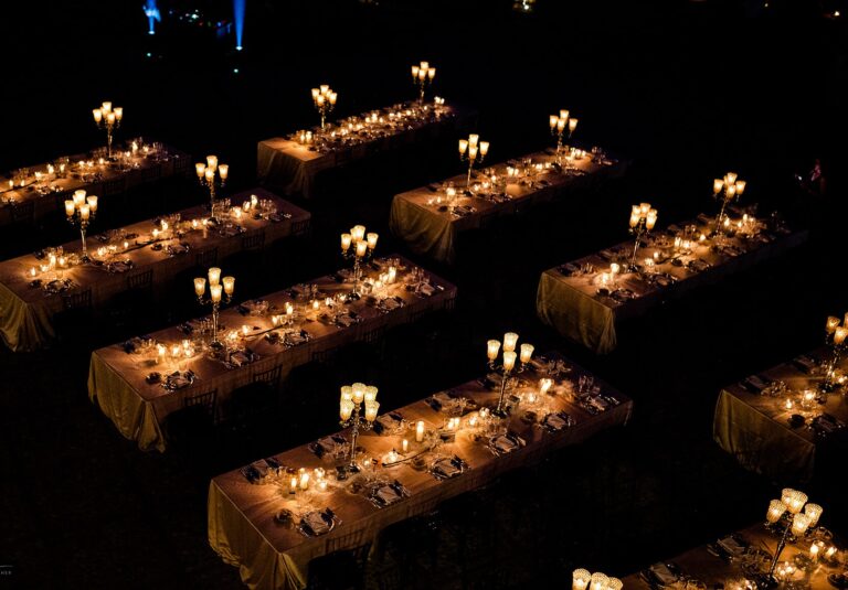 Aerial of the candlelit outdoor reception on the estate lawns at night, Castello di Solfagnano