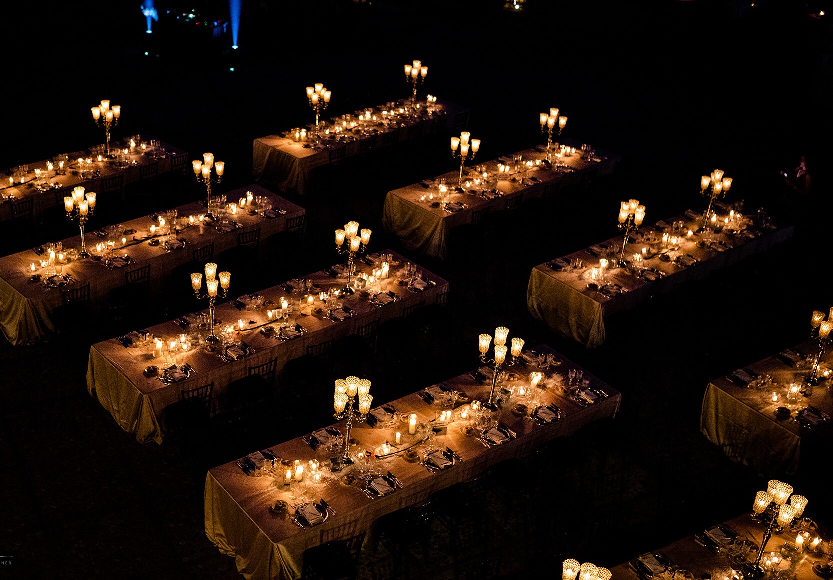 Aerial of the candlelit outdoor reception on the estate lawns at night, Castello di Solfagnano