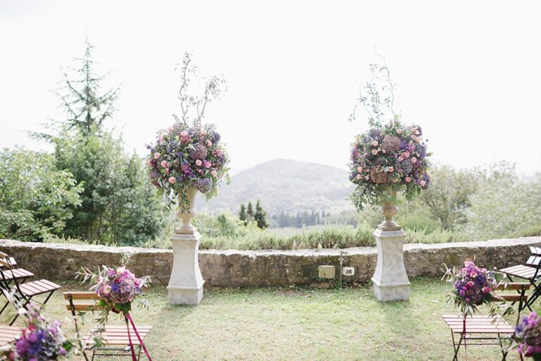 Ceremony arrangements on stone urns overlooking the hills, Caterina Weddings
