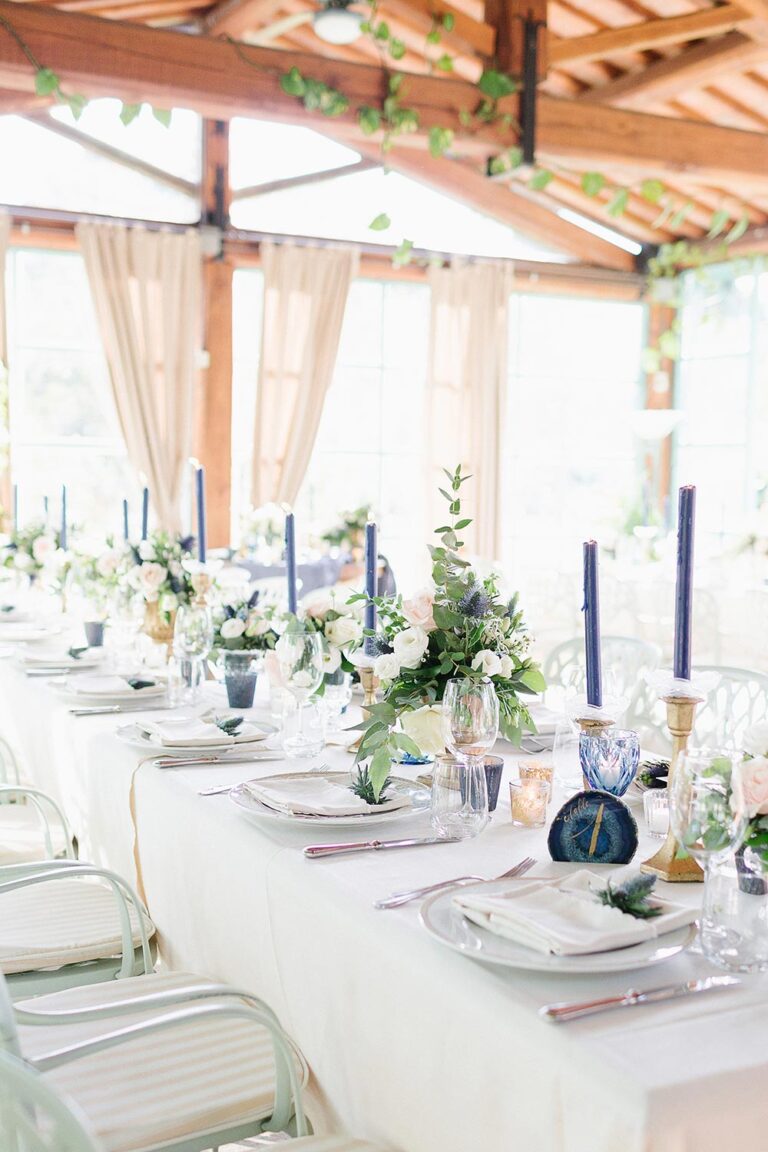 Long table in a covered terrace, dressed in blue and white, Caterina Weddings