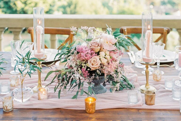 Reception table with blush flowers, candles and gold cutlery, Caterina Weddings