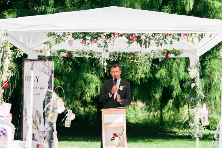 Ceremony under a floral gazebo in the park, Château de Chéronne
