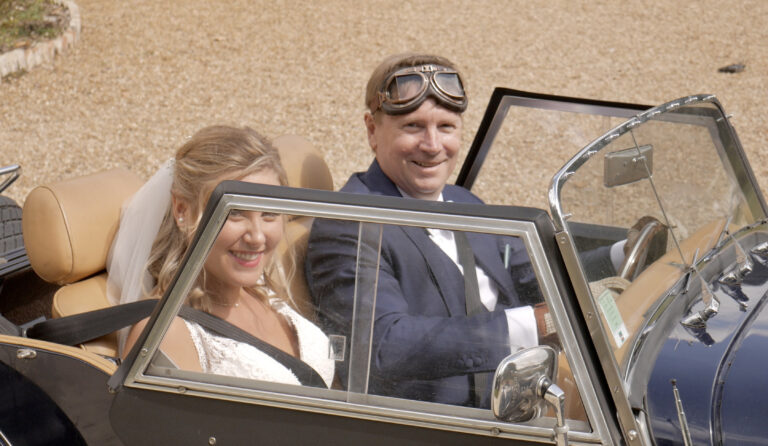 Couple arriving in a vintage open car, Château de Chéronne