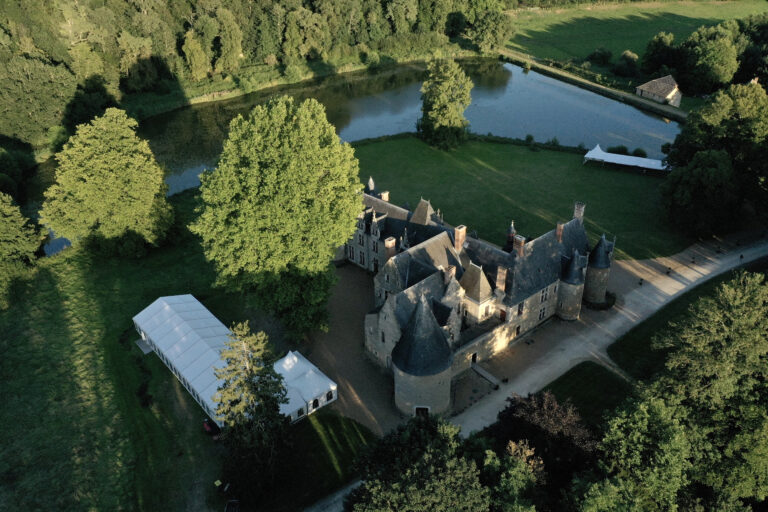 Aerial view of the chateau, its pond and the surrounding woodland, Château de Chéronne