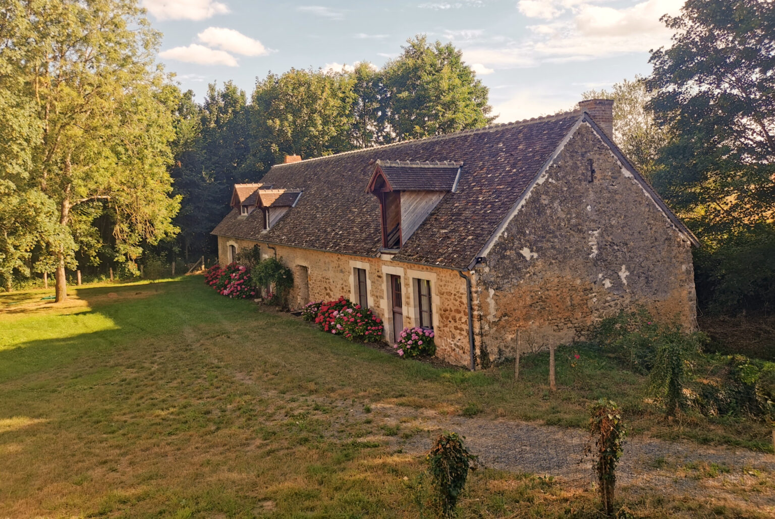 A stone gite on the estate at sunset