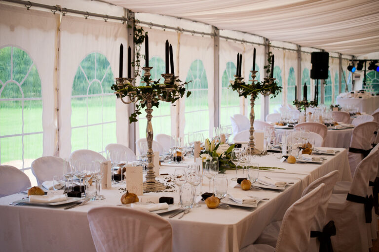 Dining table in the marquee with candelabra and flowers, Château de Chéronne