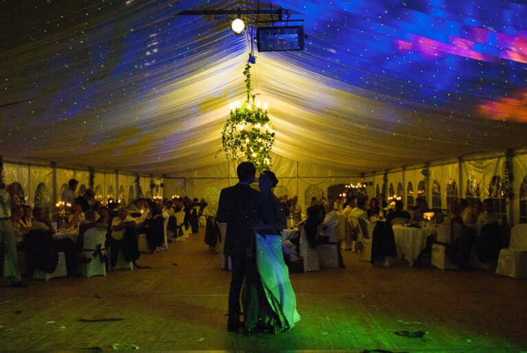 Couple dancing at night in the lit marquee, Château de Chéronne