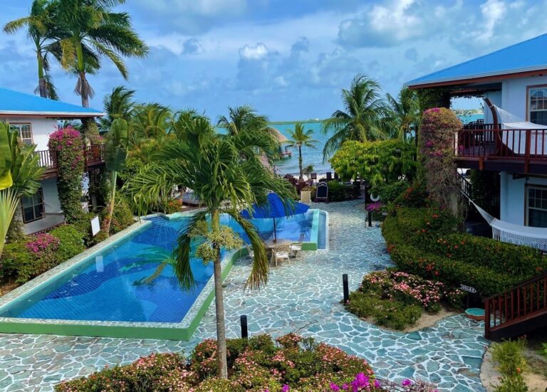 A long pool running through tropical gardens toward the villas, Chabil Mar Resort